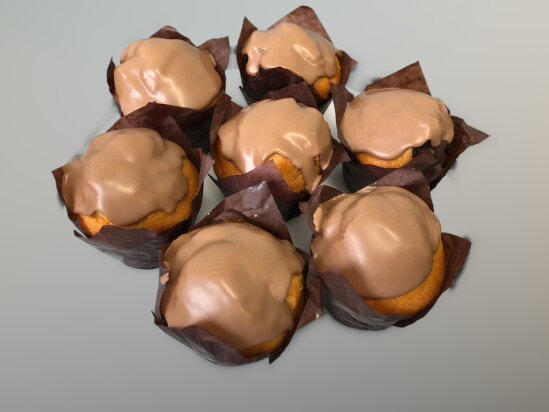 Seven muffins in brown paper cups, each topped with a smooth layer of milk chocolate