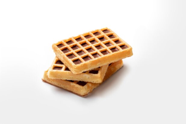 Stack of three egg waffles with compound deposited in the cavities
