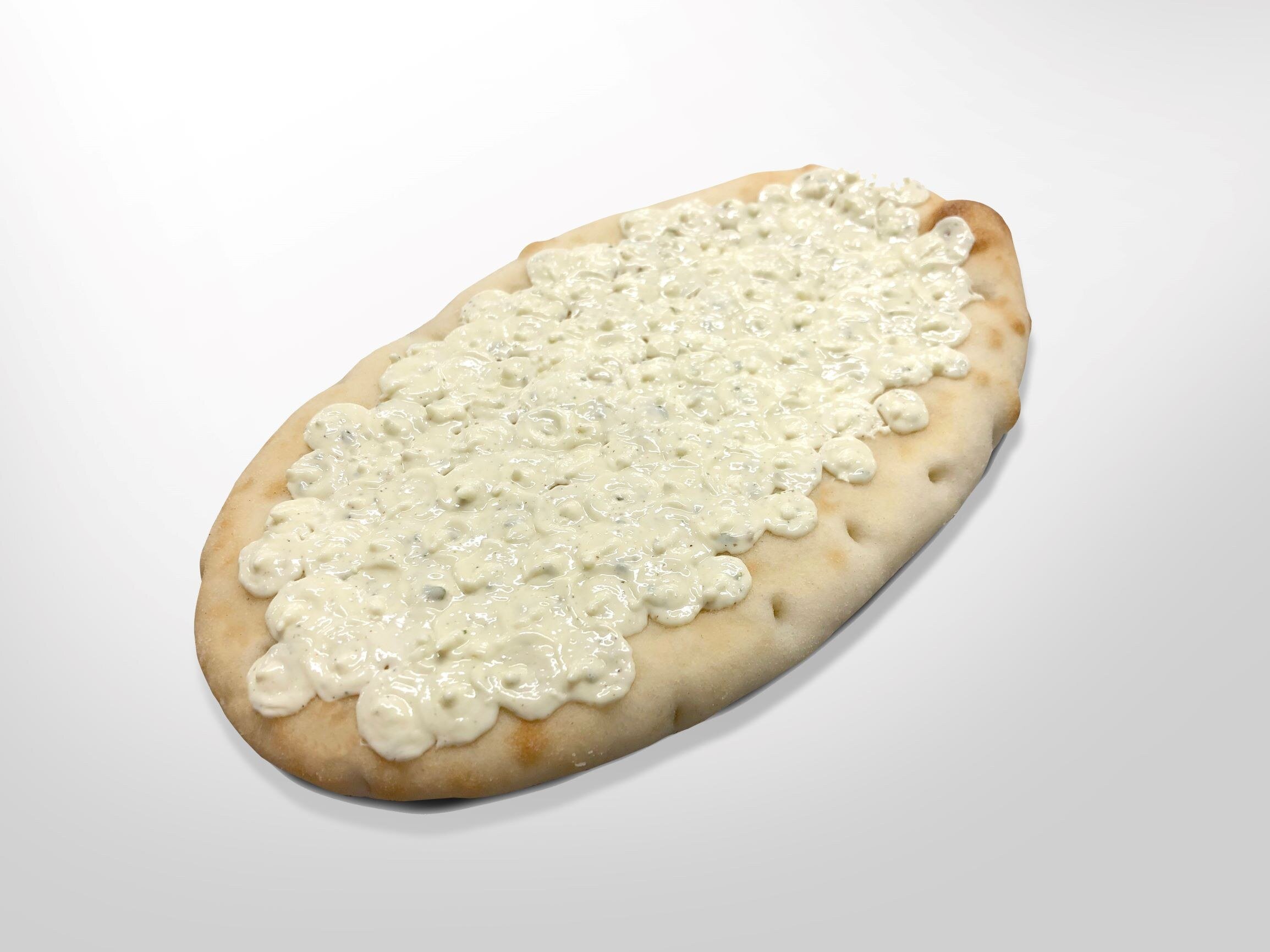 Oval flatbread with garlic butter deposited in closely spaced dots across the surface