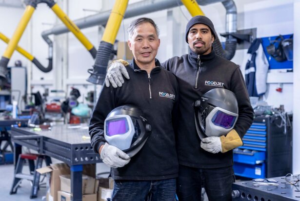 Two FoodJet welders with welding helmets in the workshop