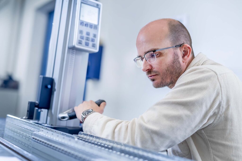 FoodJet engineer taking a measurement on a machine component