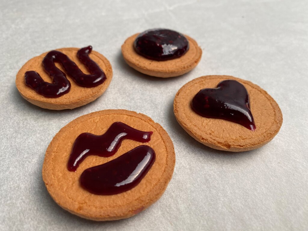 Jaffa cakes with deposited pectin jam shapes: a wave, a dot, a heart and lips