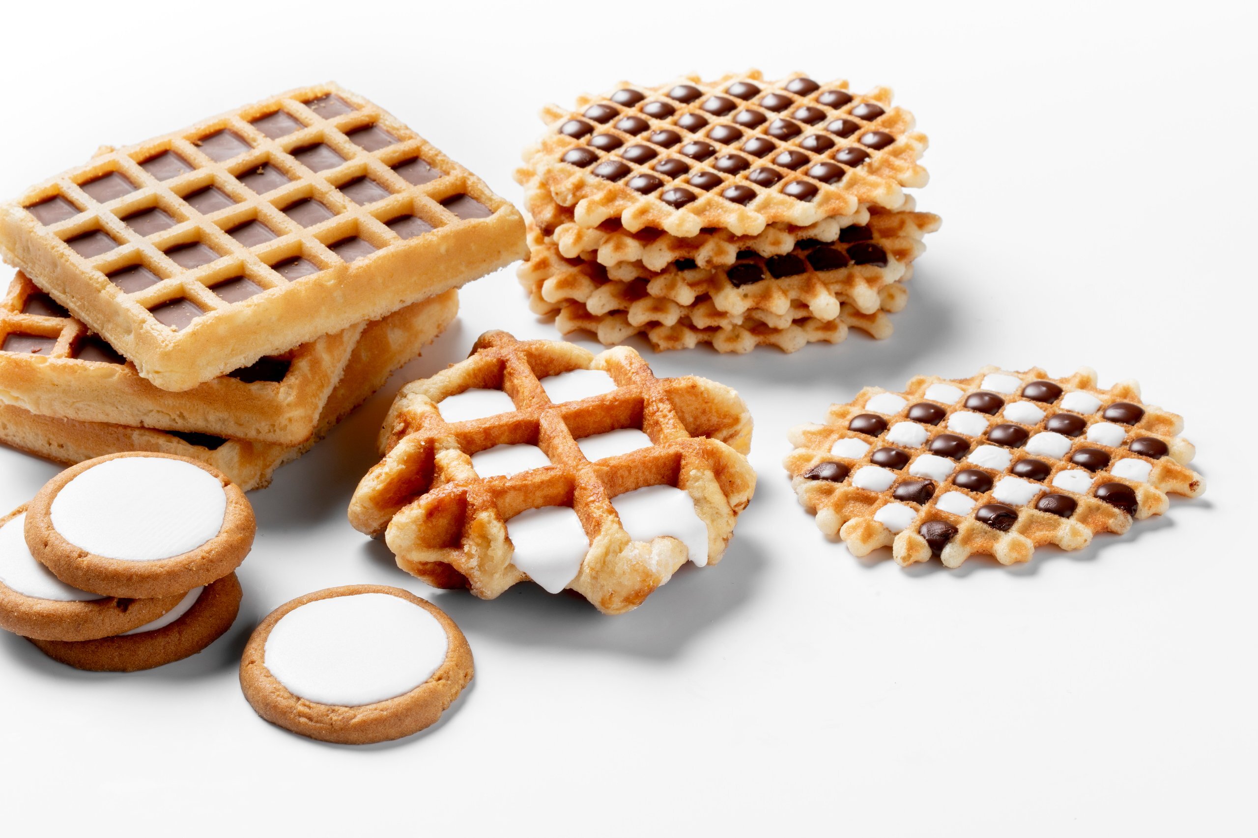Assorted waffles and biscuits with compound deposited in the cavities
