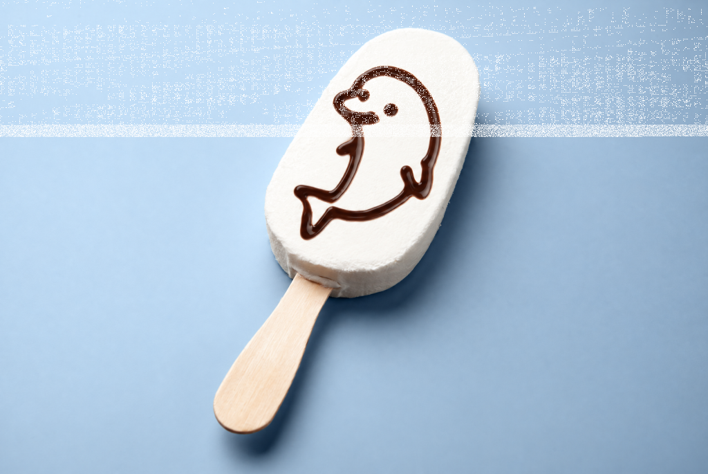 White ice cream bar on a stick decorated with a chocolate dolphin outline